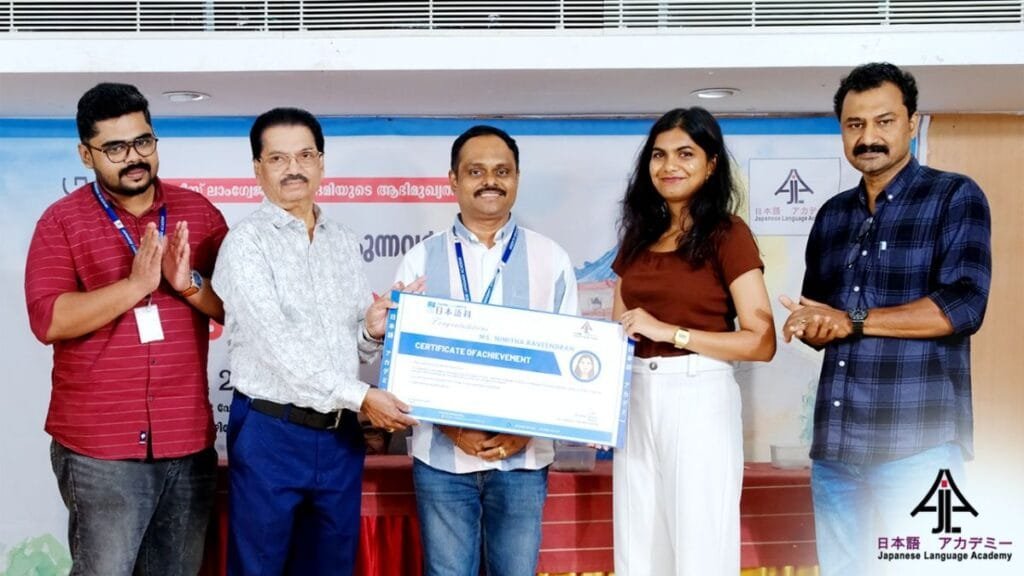 OISCA Int'l Deputy Secretary Mr. Aravind Babu presents a certificate to scholarship winner Ms. Nimitha Ravindran. Mr. Balu, Dr. Subin Vazhayil, and Mr. Feroz Khan also present